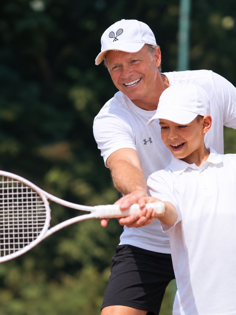 Coach Henry guiding a young player through a forehand grip