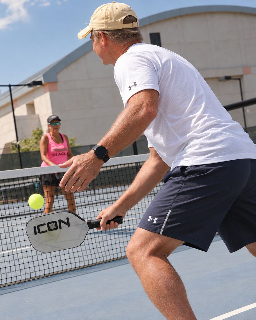 Coach Henry trading shots at the net during a drill